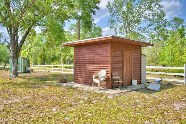 a room with stainless steel appliances wooden floor and dining table