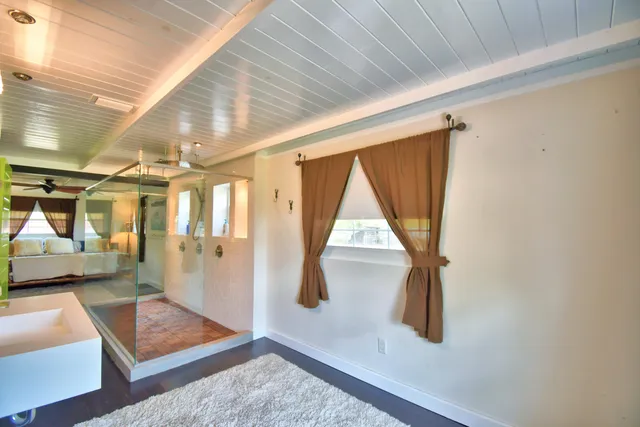 a kitchen with stainless steel appliances a refrigerator a stove and white cabinets