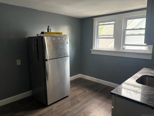 a kitchen with a refrigerator and window