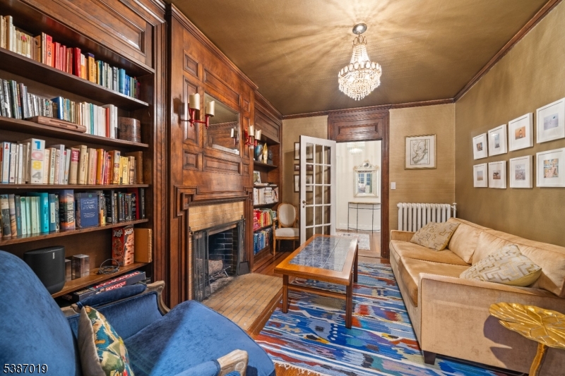 655 Lake Street Newark, NJ 07104 - Photo 22 of 49 a living room with furniture a bookshelf and a book shelf