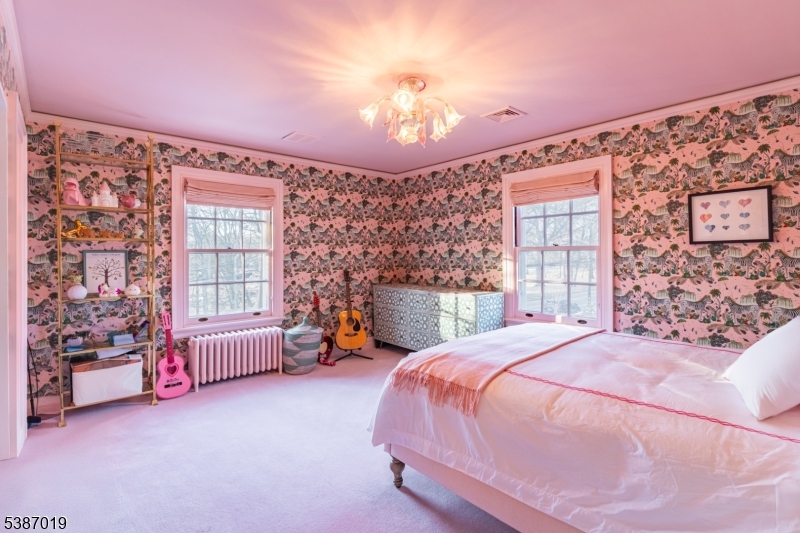 655 Lake Street Newark, NJ 07104 - Photo 33 of 49 a spacious bedroom with a bed couch and a window