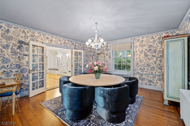 655 Lake Street Newark, NJ 07104 - Photo 10 of 49 a dining room with chandelier and wooden floor