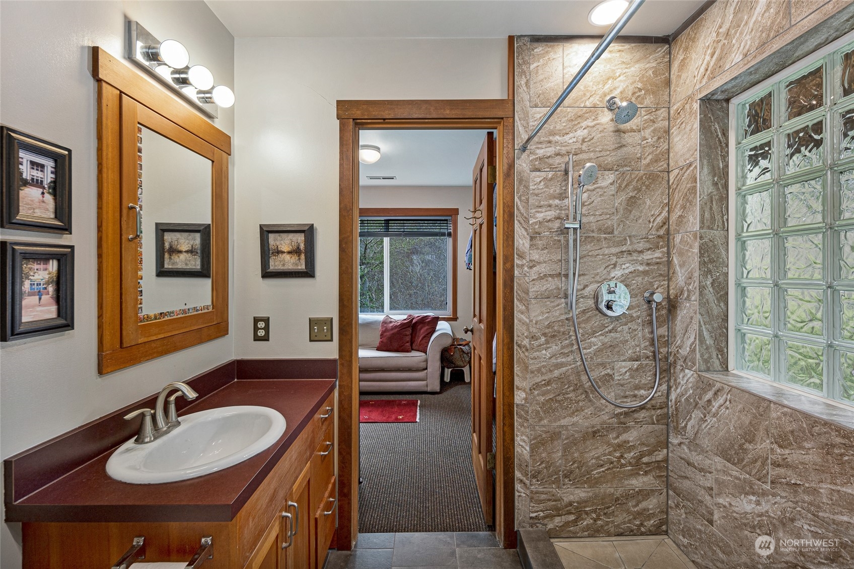 4484 Cattle Point Road Friday Harbor, WA 98250 - Photo 18 of 22 a en suite bathroom with a sink a mirror a window and shower