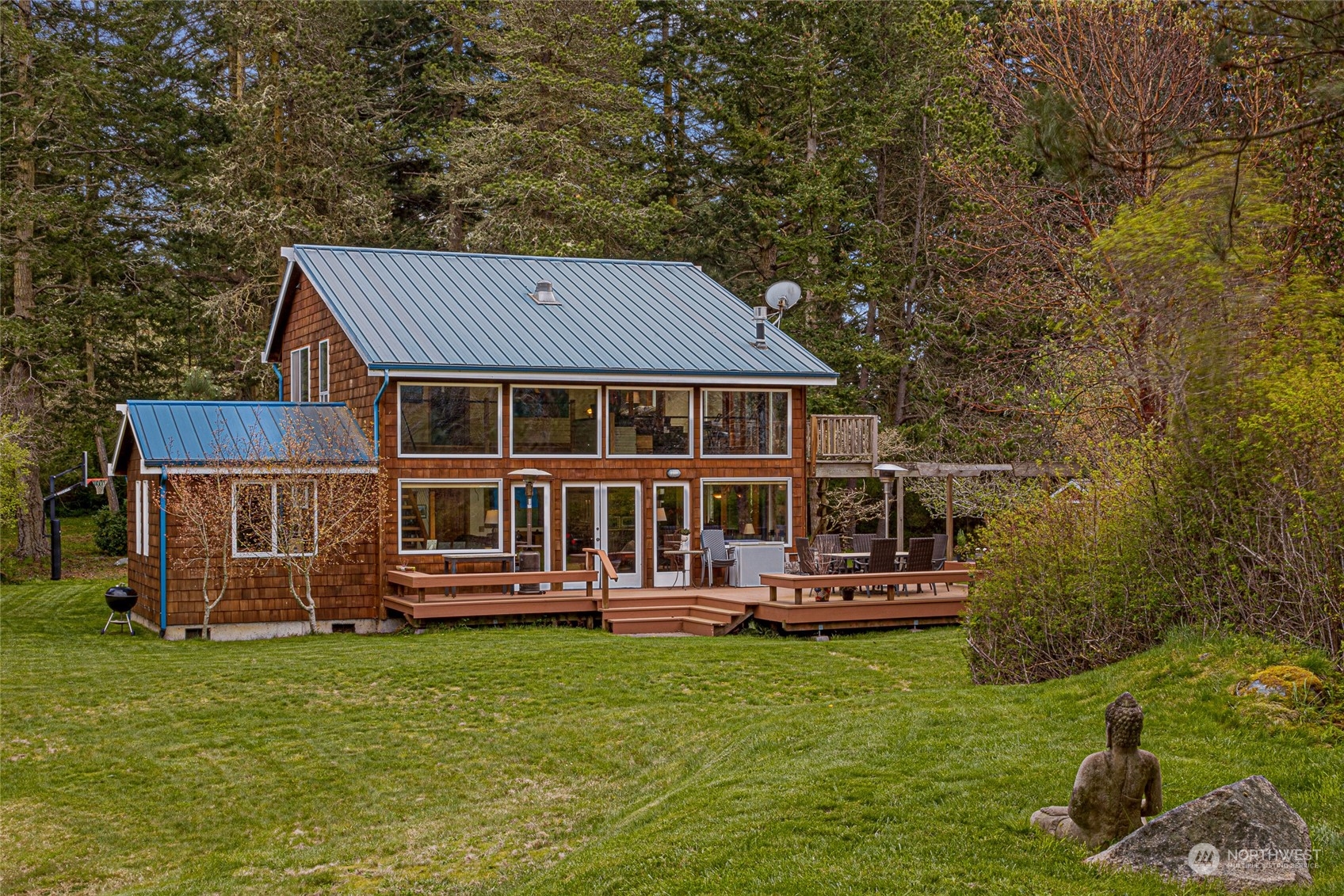 4484 Cattle Point Road Friday Harbor, WA 98250 - Photo 5 of 22 front view of a house with a yard table and chairs