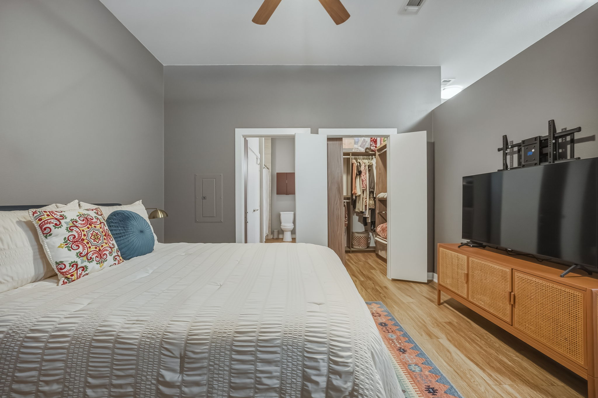 1900 Barton Springs Road, Unit 2006 Austin, TX 78704 - Photo 11 of 26 a bedroom with a bed and a flat tv screen on dresser