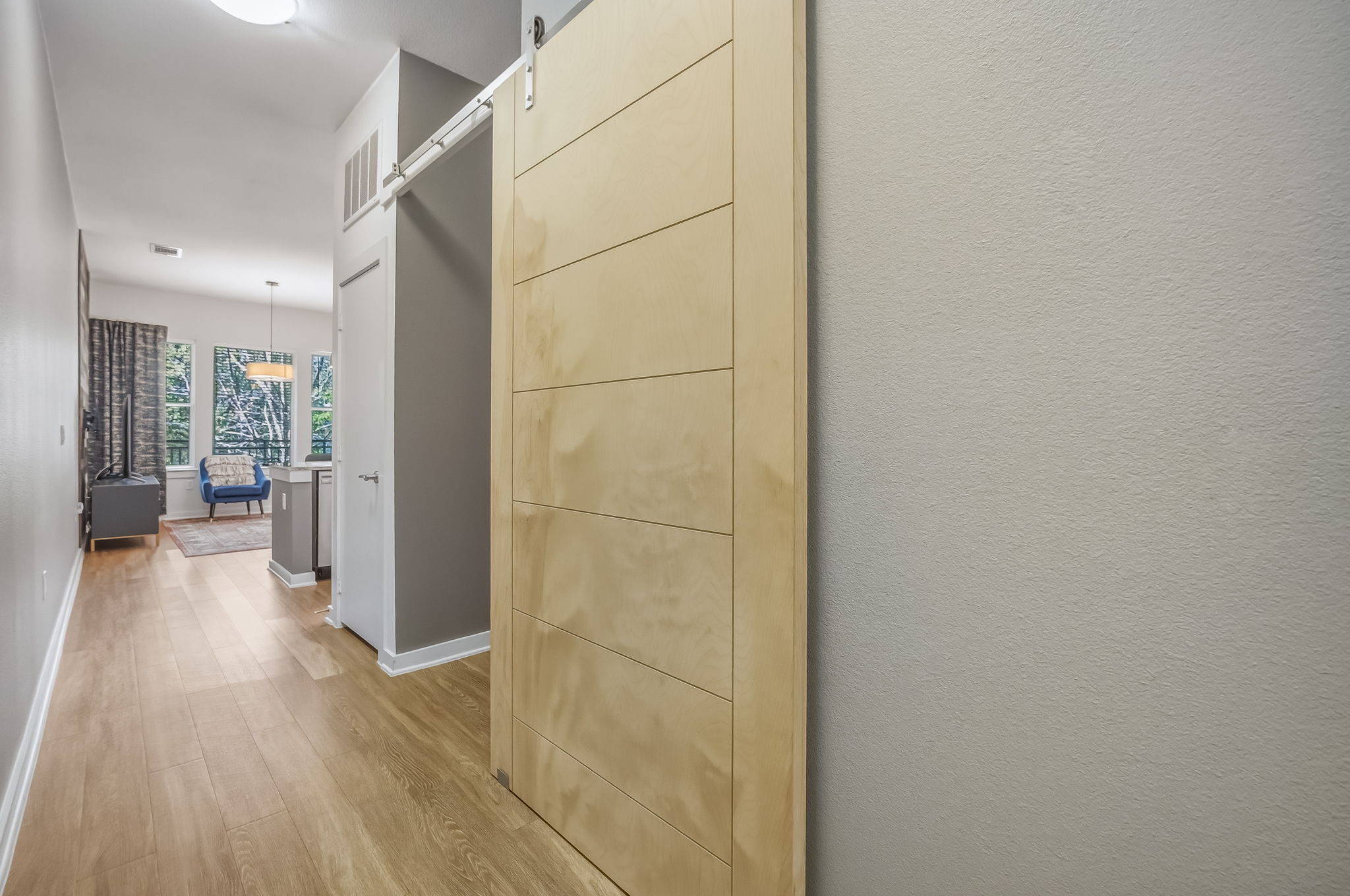 1900 Barton Springs Road, Unit 2006 Austin, TX 78704 - Photo 4 of 26 a view of a hallway with wooden floor and a living room