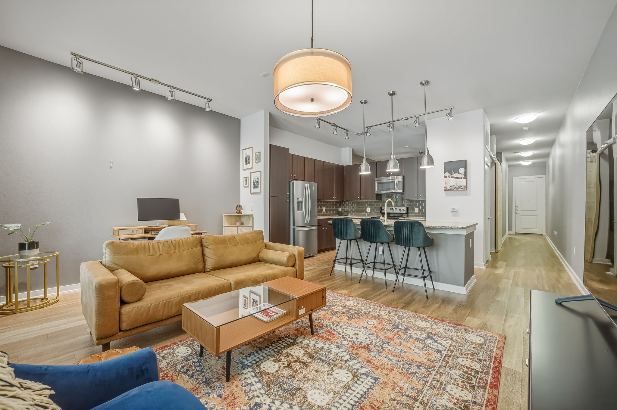 1900 Barton Springs Road, Unit 2006 Austin, TX 78704 - Photo 7 of 26 a living room with furniture a rug and kitchen view