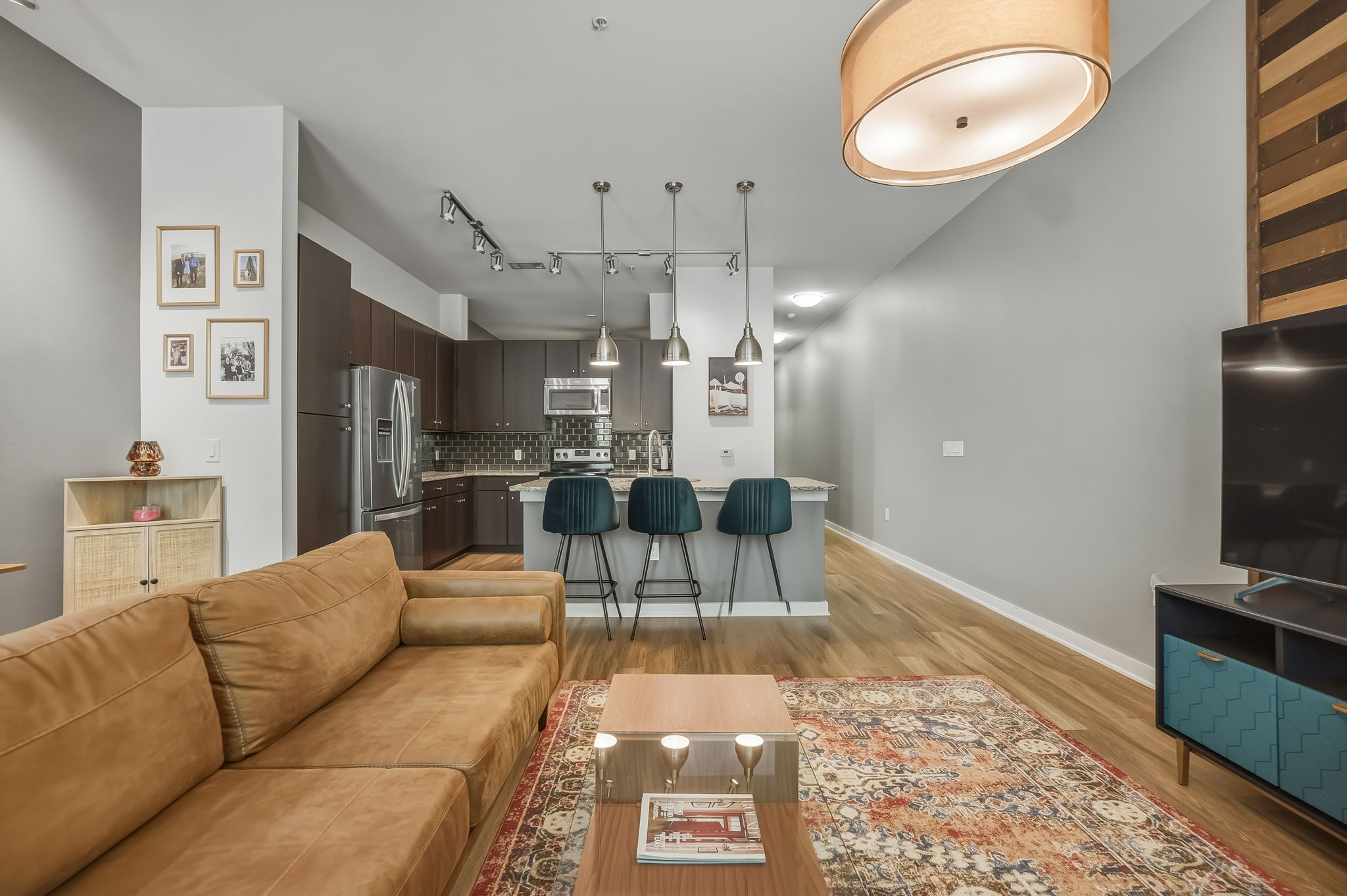1900 Barton Springs Road, Unit 2006 Austin, TX 78704 - Photo 8 of 26 a living room with furniture a flat screen tv and kitchen view