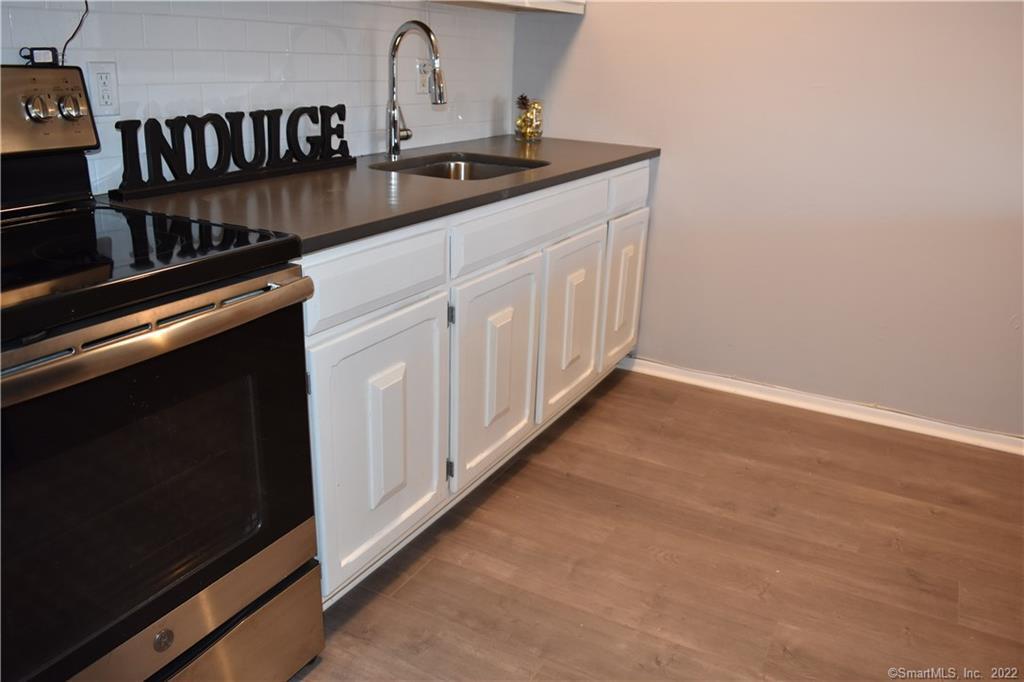 34 Bostwick Arms, Unit 34 New Milford, CT 06776 - Photo 4 of 11 a kitchen with a sink and cabinets