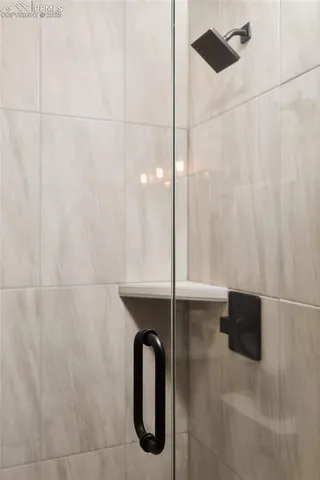 a bathroom with a shower and a sink