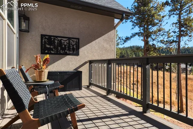 a balcony with table and chairs
