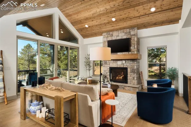 a living room with furniture large window and a fireplace