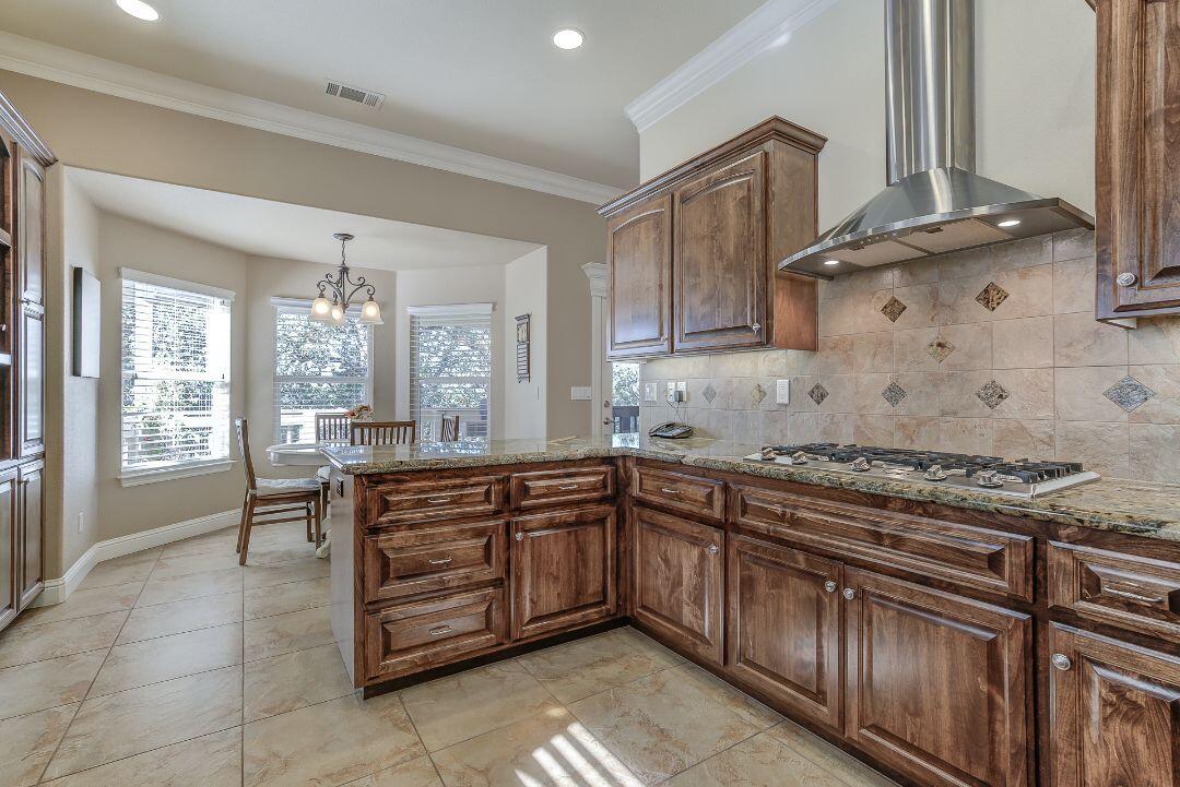 380 Franciscan Trail Redding, CA 96003 - Photo 22 of 78 a kitchen with stainless steel appliances granite countertop a sink and cabinets