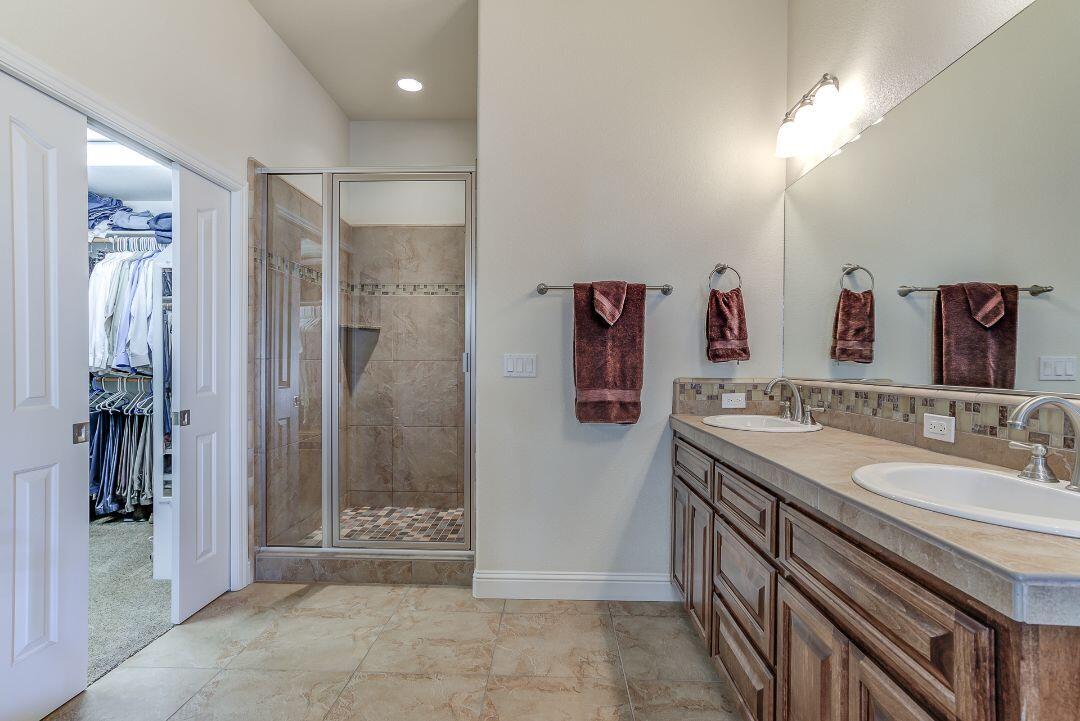 380 Franciscan Trail Redding, CA 96003 - Photo 32 of 78 a bathroom with a mirror sink and shower