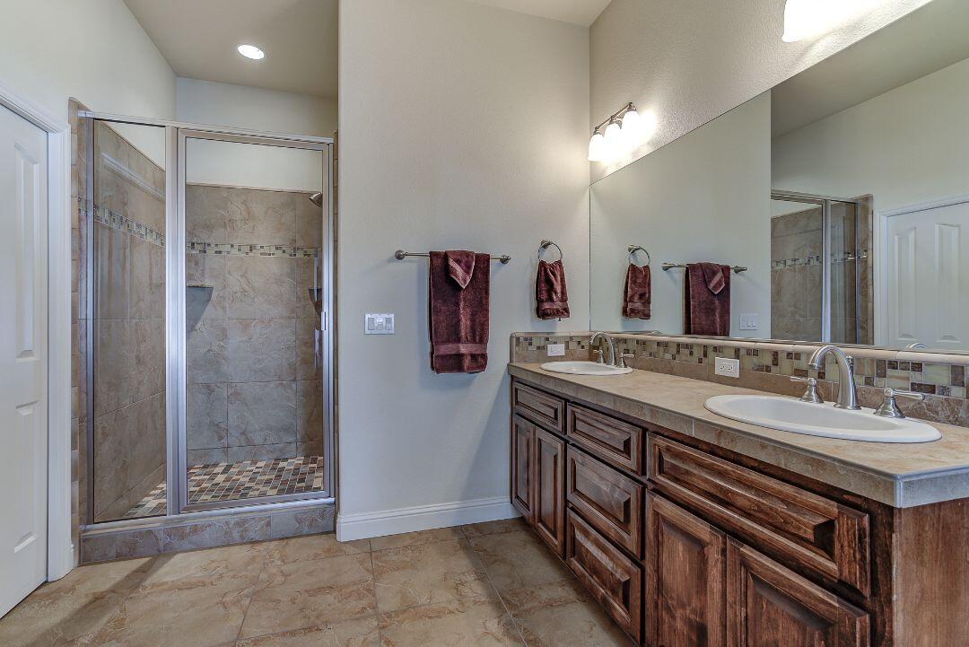 380 Franciscan Trail Redding, CA 96003 - Photo 35 of 78 a bathroom with a double vanity sink mirror and shower