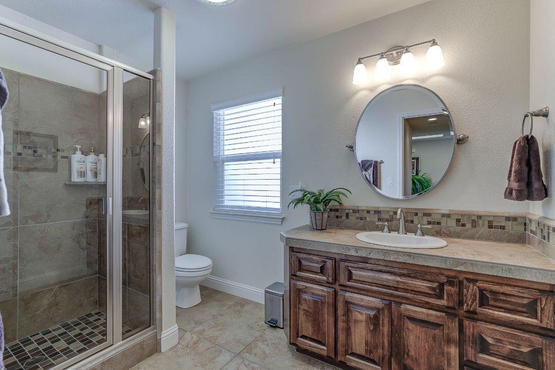 380 Franciscan Trail Redding, CA 96003 - Photo 38 of 78 a bathroom with a sink and a mirror