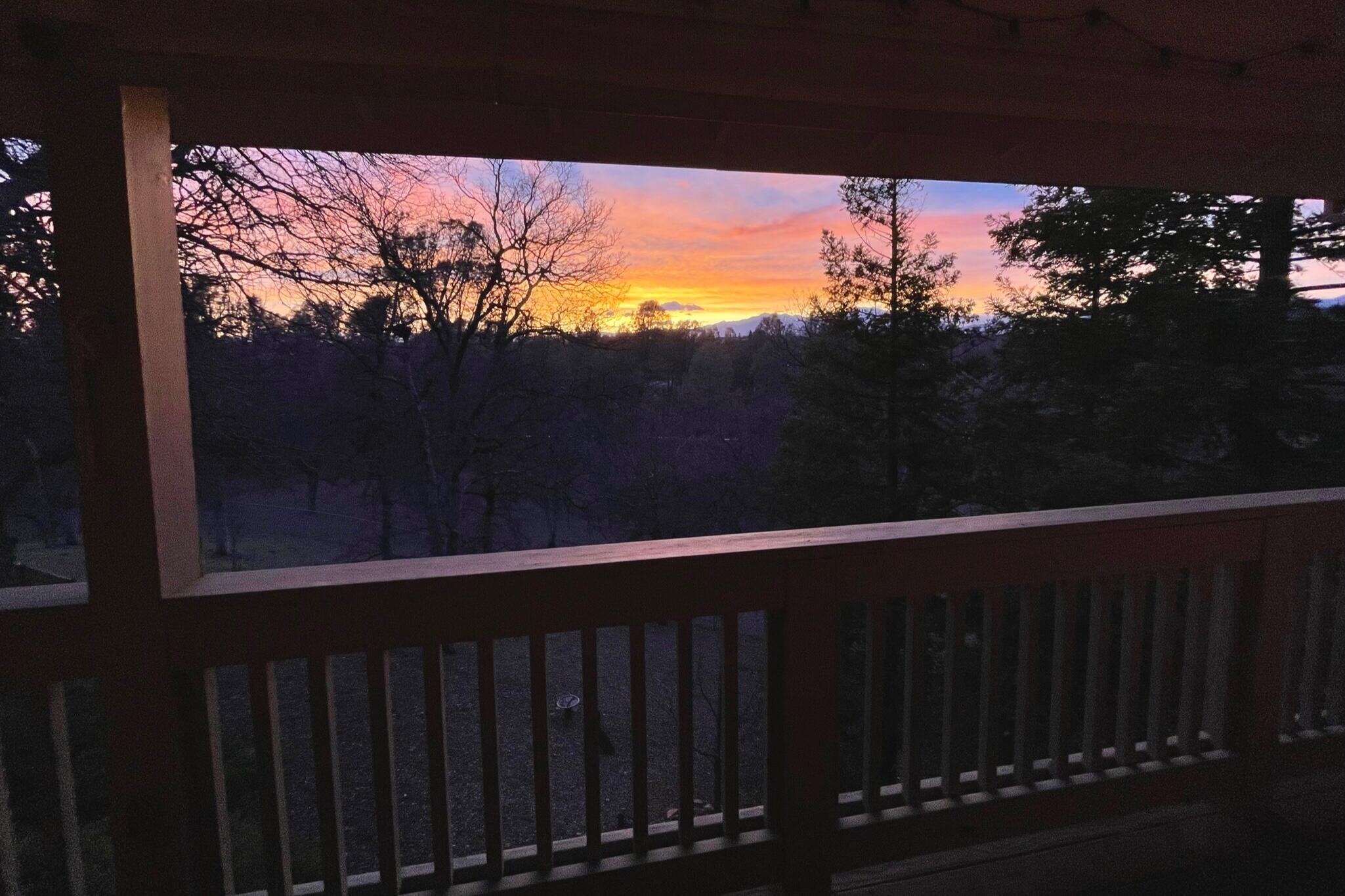 380 Franciscan Trail Redding, CA 96003 - Photo 46 of 78 a wooden deck with sunset view