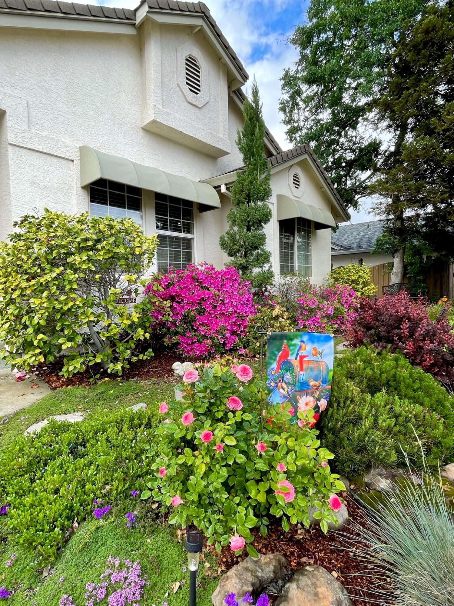 380 Franciscan Trail Redding, CA 96003 - Photo 69 of 78 a front view of a house with lots of flower plants