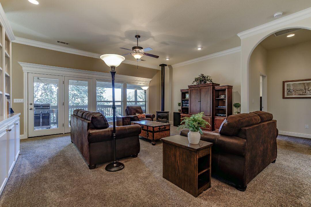 380 Franciscan Trail Redding, CA 96003 - Photo 10 of 78 a living room with furniture and a chandelier