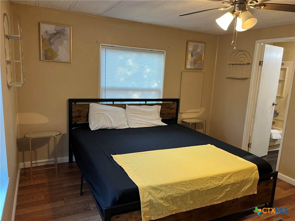 5576 Helm Lane Temple, TX 76502 - Photo 18 of 25 a bedroom with a bed and wooden floor