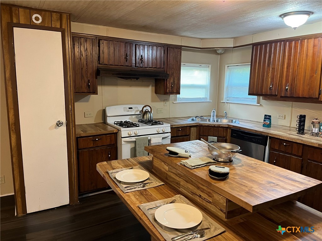 5576 Helm Lane Temple, TX 76502 - Photo 9 of 25 a kitchen with a sink a stove and wooden floor
