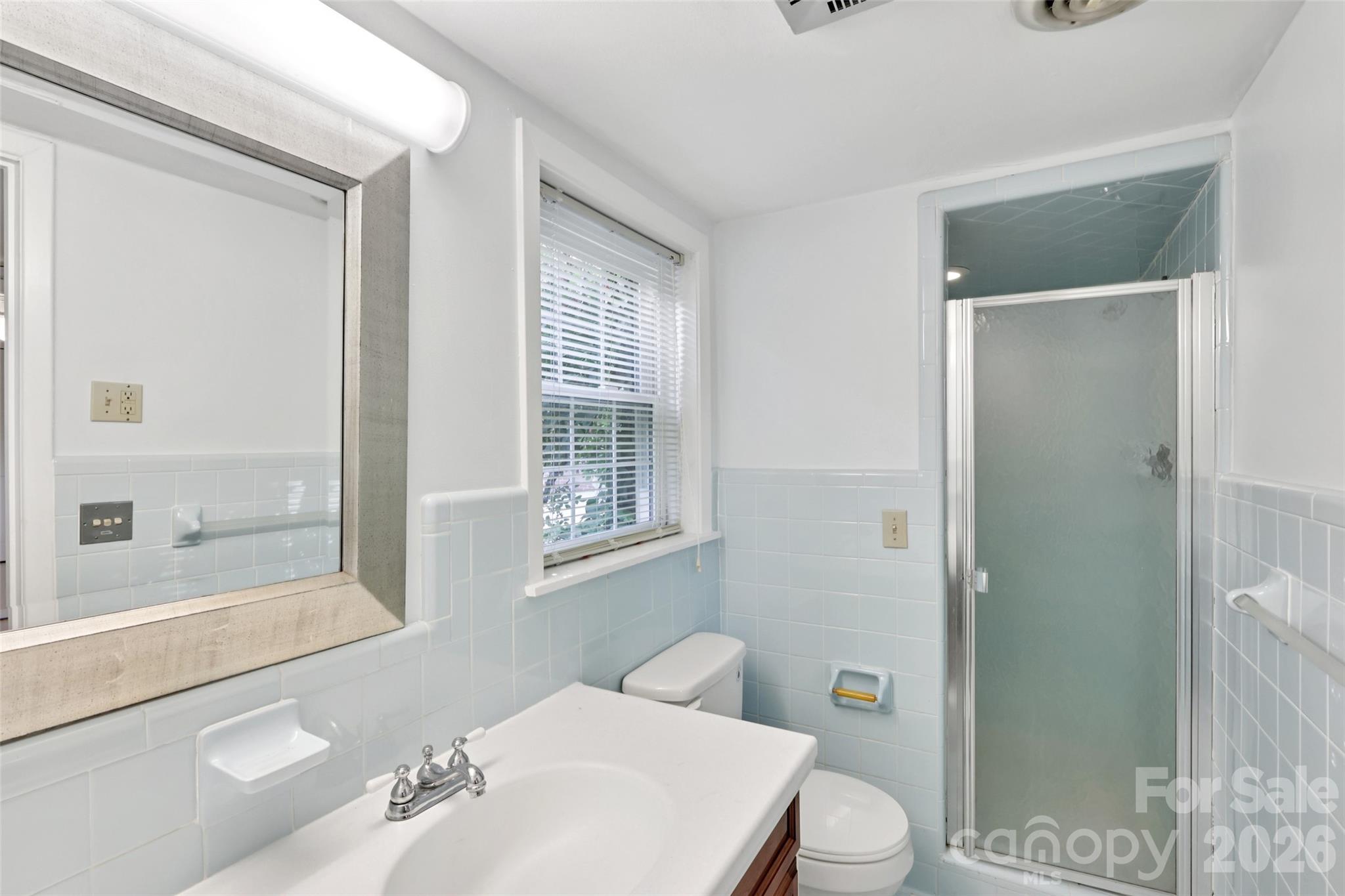 1002 Ridge Street Albemarle, NC 28001 - Photo 34 of 45 a white toilet sitting next to a bathroom sink
