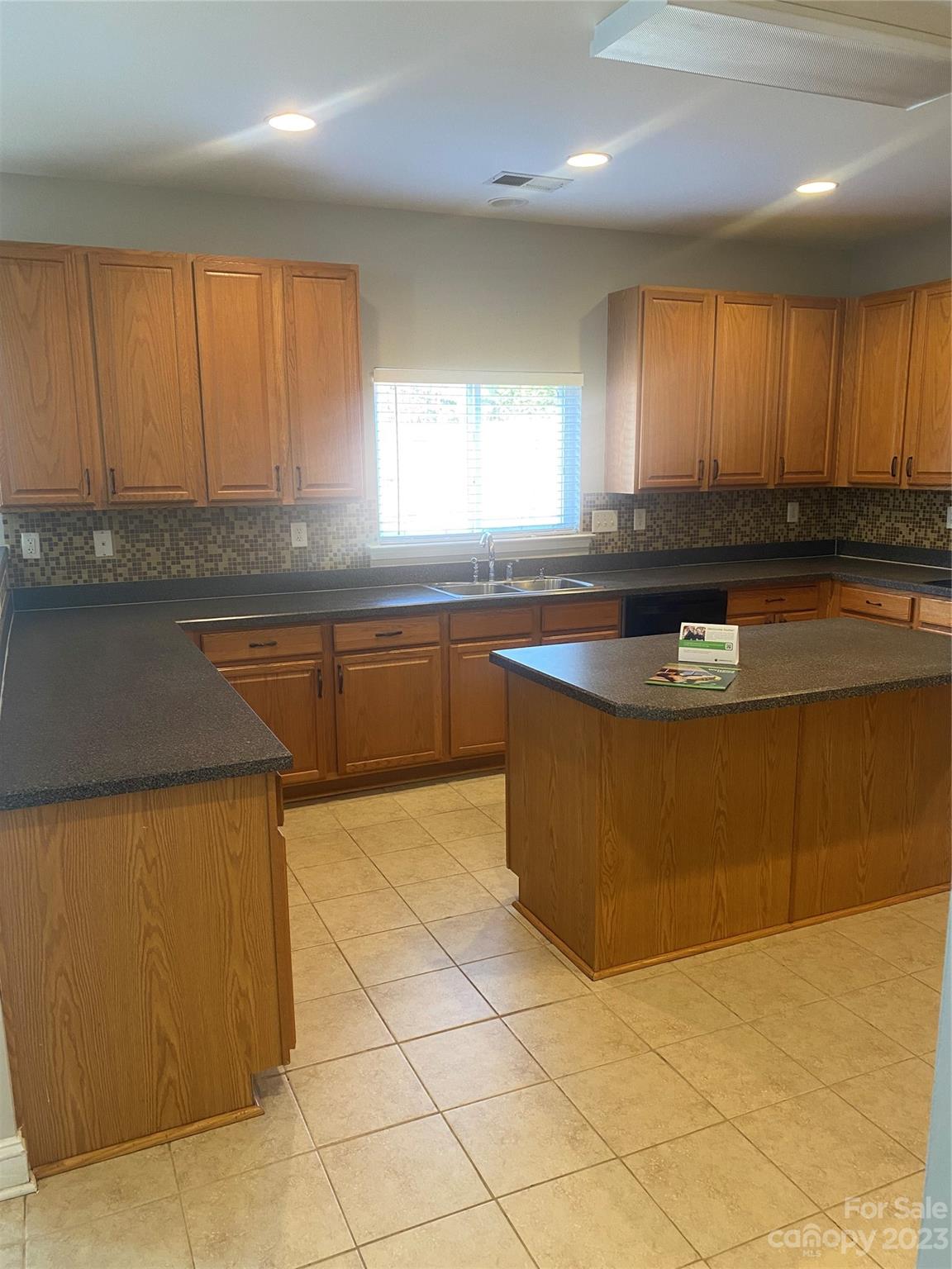 7808 Kuck Road Mint Hill, NC 28227 - Photo 12 of 34 a kitchen with stainless steel appliances granite countertop a sink a stove a counter top space and cabinets