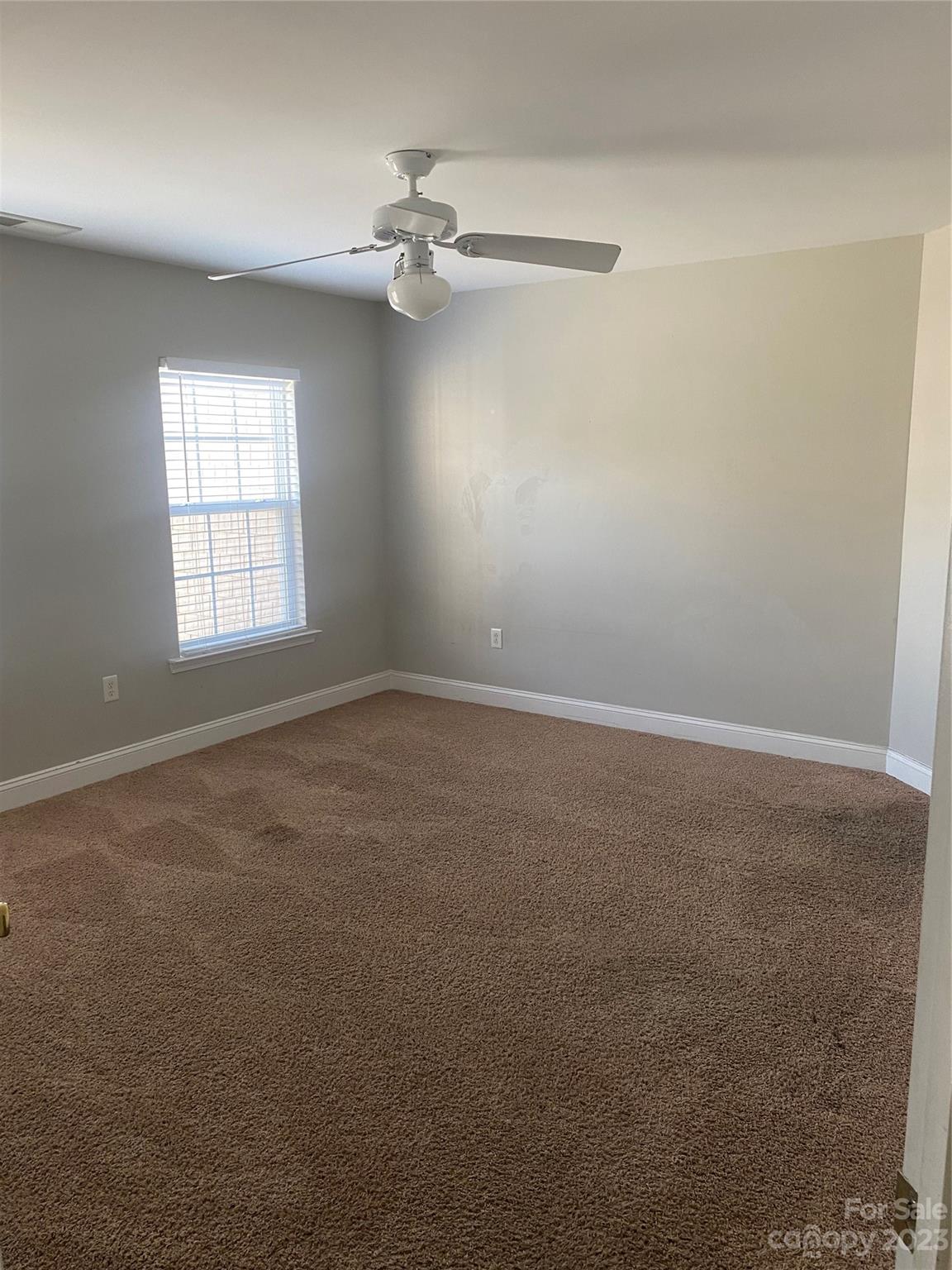 7808 Kuck Road Mint Hill, NC 28227 - Photo 22 of 34 an empty room with windows and fan