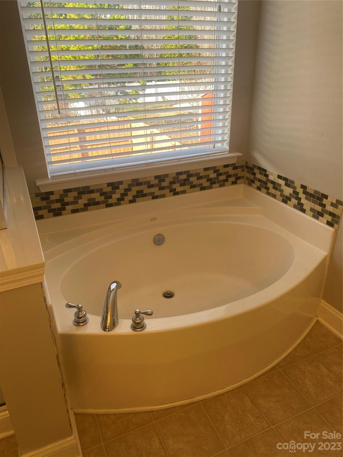 7808 Kuck Road Mint Hill, NC 28227 - Photo 31 of 34 a bath tub sitting in a bathroom next to a window