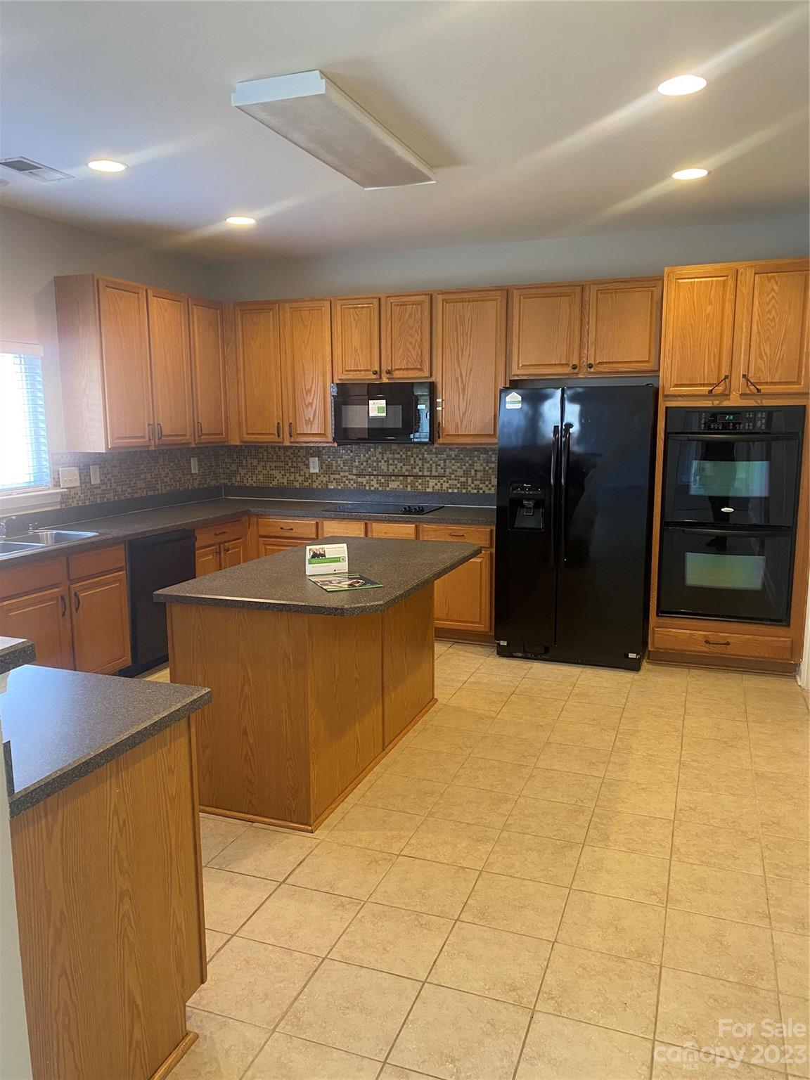 7808 Kuck Road Mint Hill, NC 28227 - Photo 4 of 34 a kitchen with stainless steel appliances granite countertop a stove a sink and a refrigerator