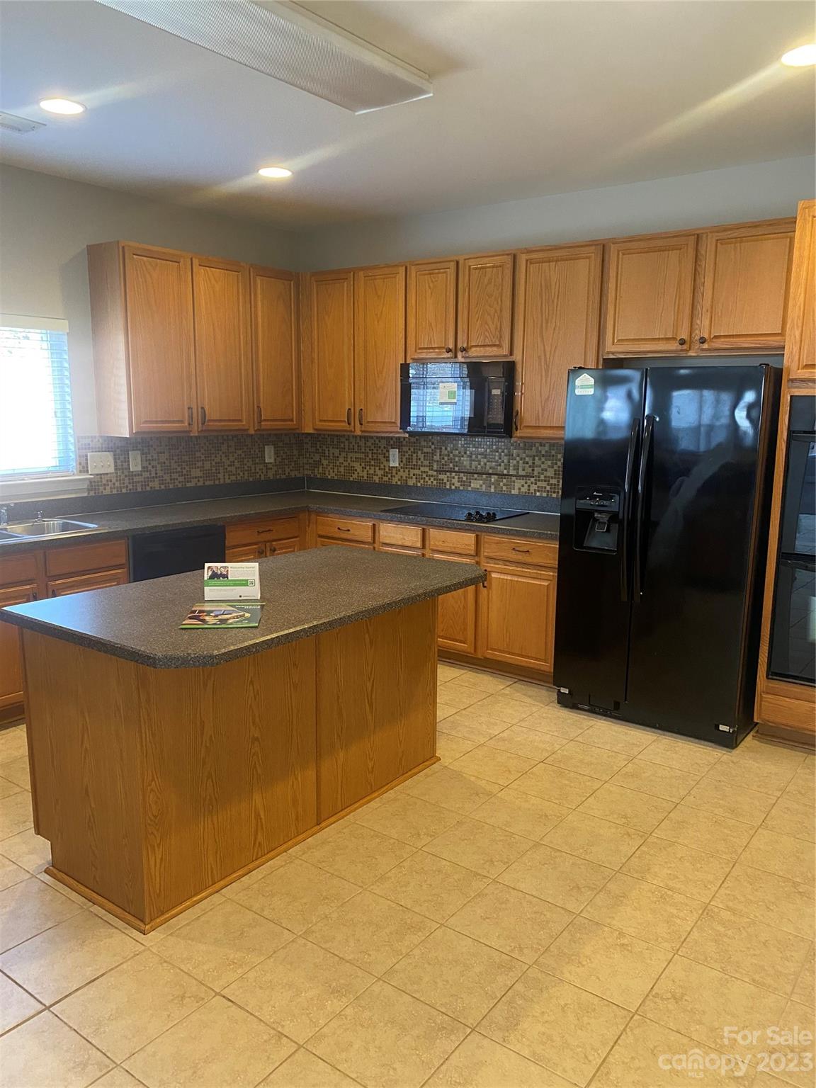 7808 Kuck Road Mint Hill, NC 28227 - Photo 5 of 34 a kitchen with stainless steel appliances granite countertop a sink a stove and a refrigerator