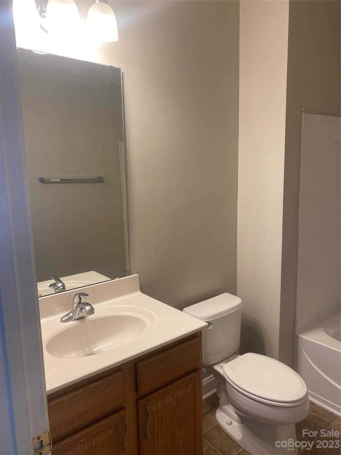 7808 Kuck Road Mint Hill, NC 28227 - Photo 9 of 34 a bathroom with a sink toilet and a mirror