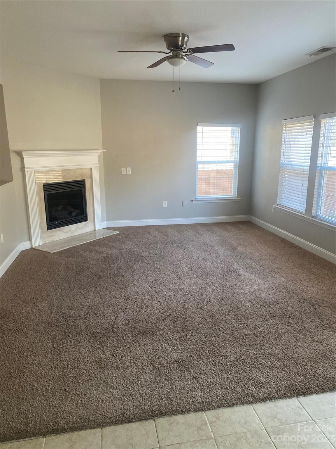 7808 Kuck Road Mint Hill, NC 28227 - Photo 10 of 34 an empty room with windows and fireplace