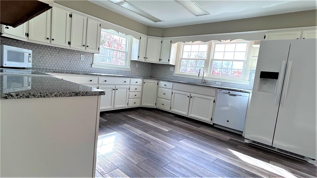 236 Smith Road Franklin, PA 16323 - Photo 6 of 22 a kitchen with granite countertop white cabinets and white appliances