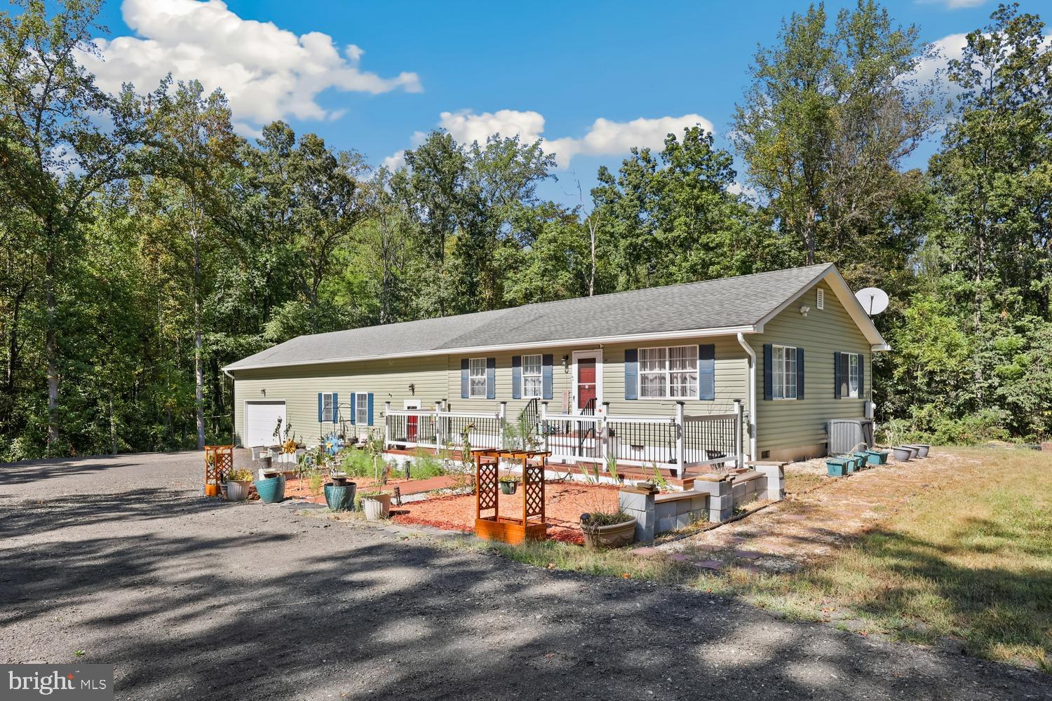 a view of a house with garden and patio