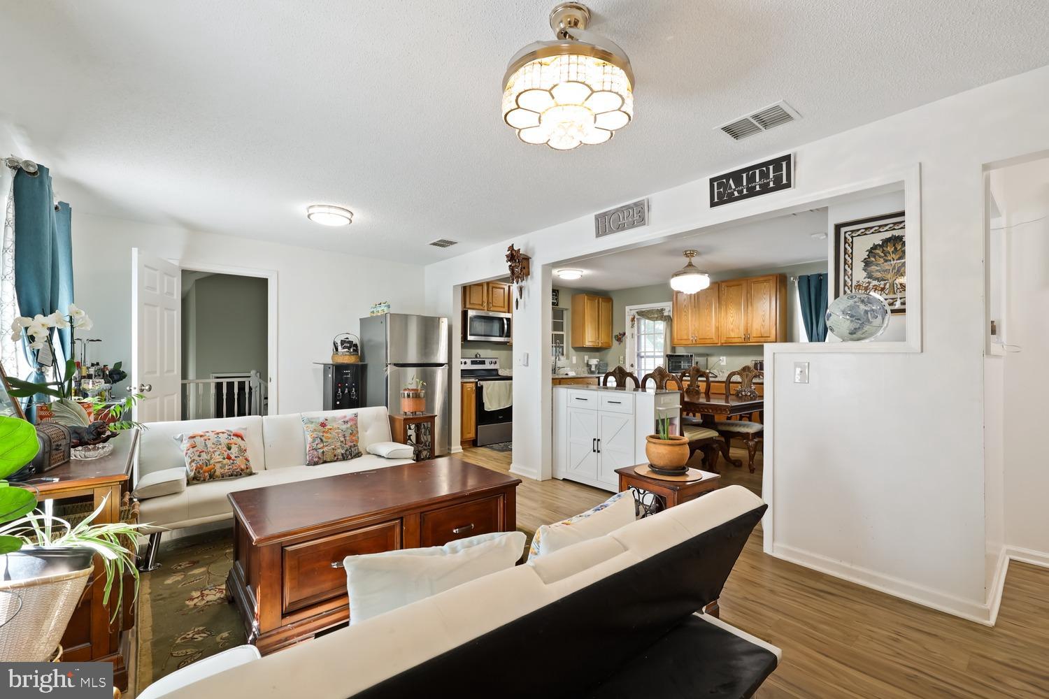 9463 Rogues Road Midland, VA 22728 - Photo 11 of 35 a room with a table chairs and wooden floor