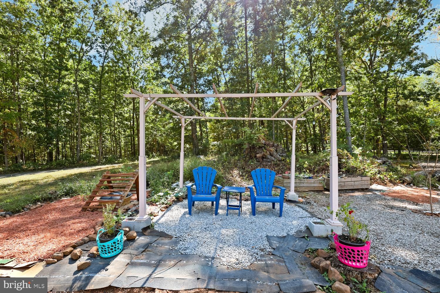 9463 Rogues Road Midland, VA 22728 - Photo 30 of 35 a view of a patio with table and chairs potted plants with wooden fence