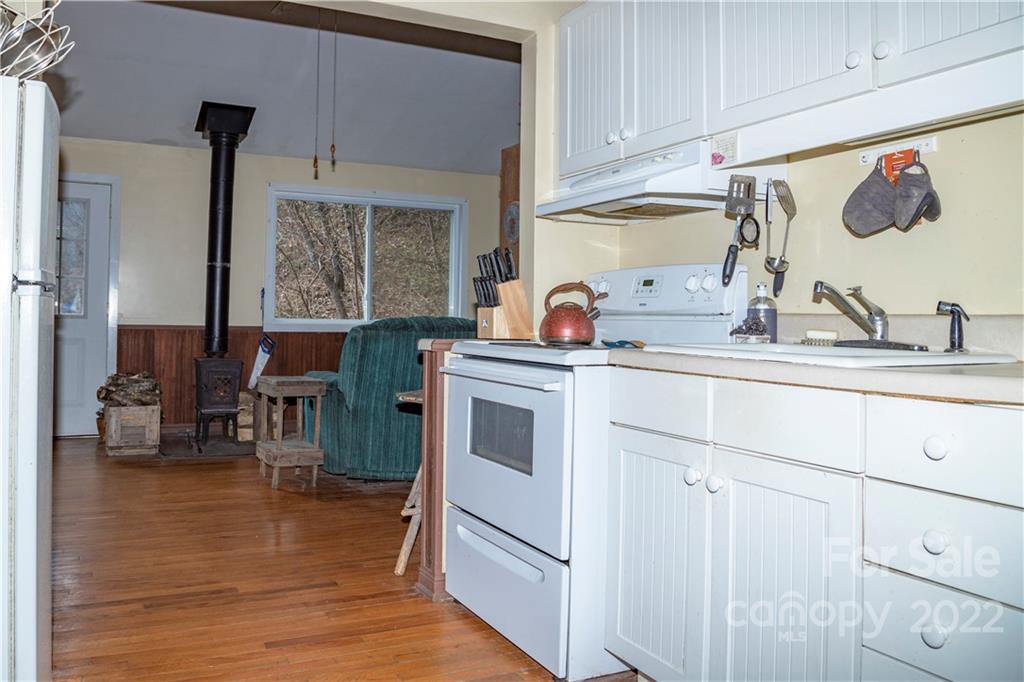 7442 Little Pine Road Marshall, NC 28753 - Photo 7 of 35 a kitchen with stainless steel appliances granite countertop a sink stove and cabinets