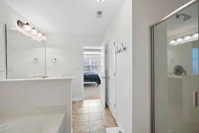 a bathroom with a tub and shower
