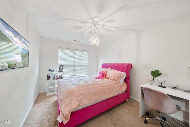 a bedroom with a bed and a table in it