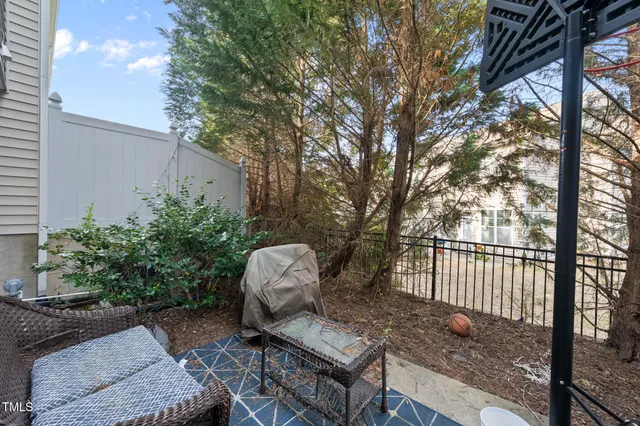 a view of a chair and table in backyard