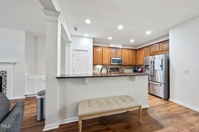 a kitchen with stainless steel appliances granite countertop a refrigerator and microwave