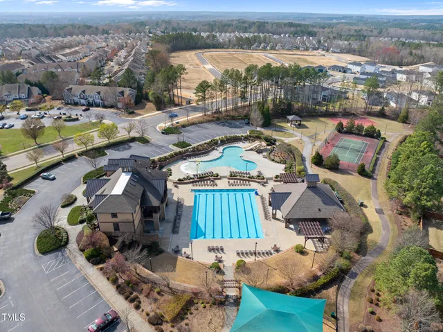 an aerial view of a house with swimming pool and ocean view