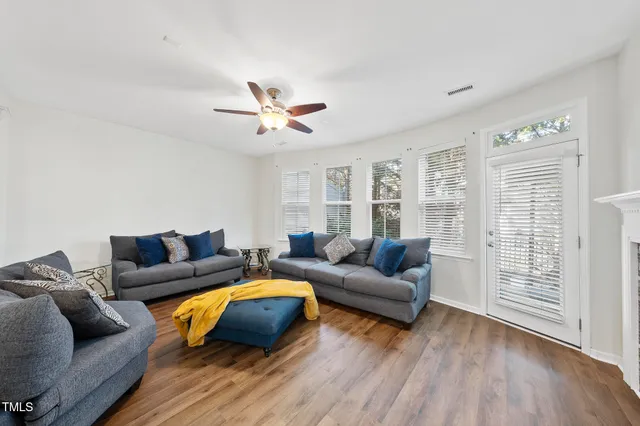 a living room with furniture and wooden floor