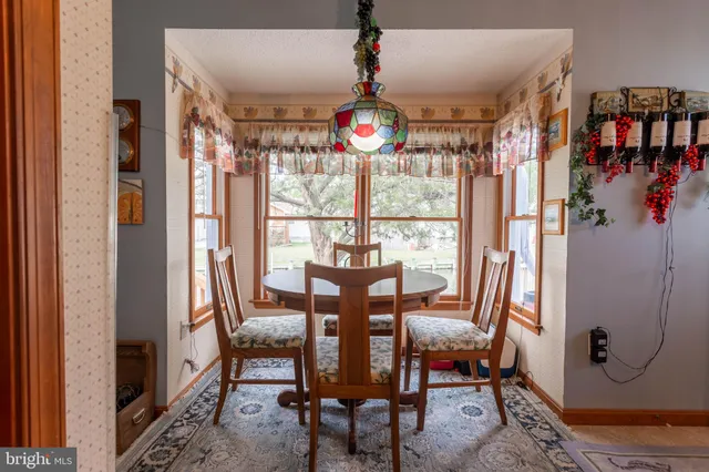 a view of a dining room with furniture and a window