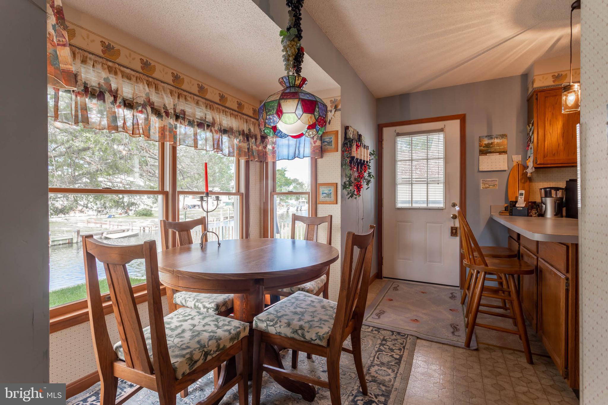 32396 Holly Ter Road Ocean View, DE 19970 - Photo 12 of 42 a dining room with furniture and window