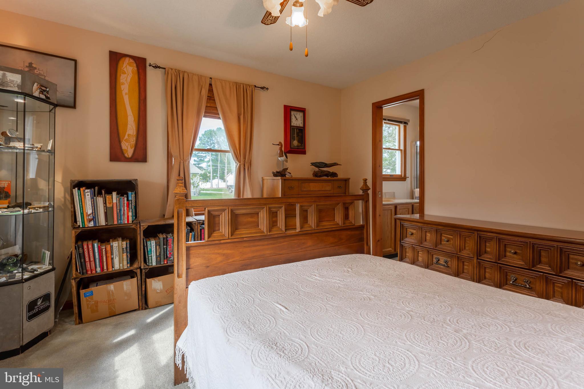 32396 Holly Ter Road Ocean View, DE 19970 - Photo 20 of 42 a bedroom with a bed and a book shelf