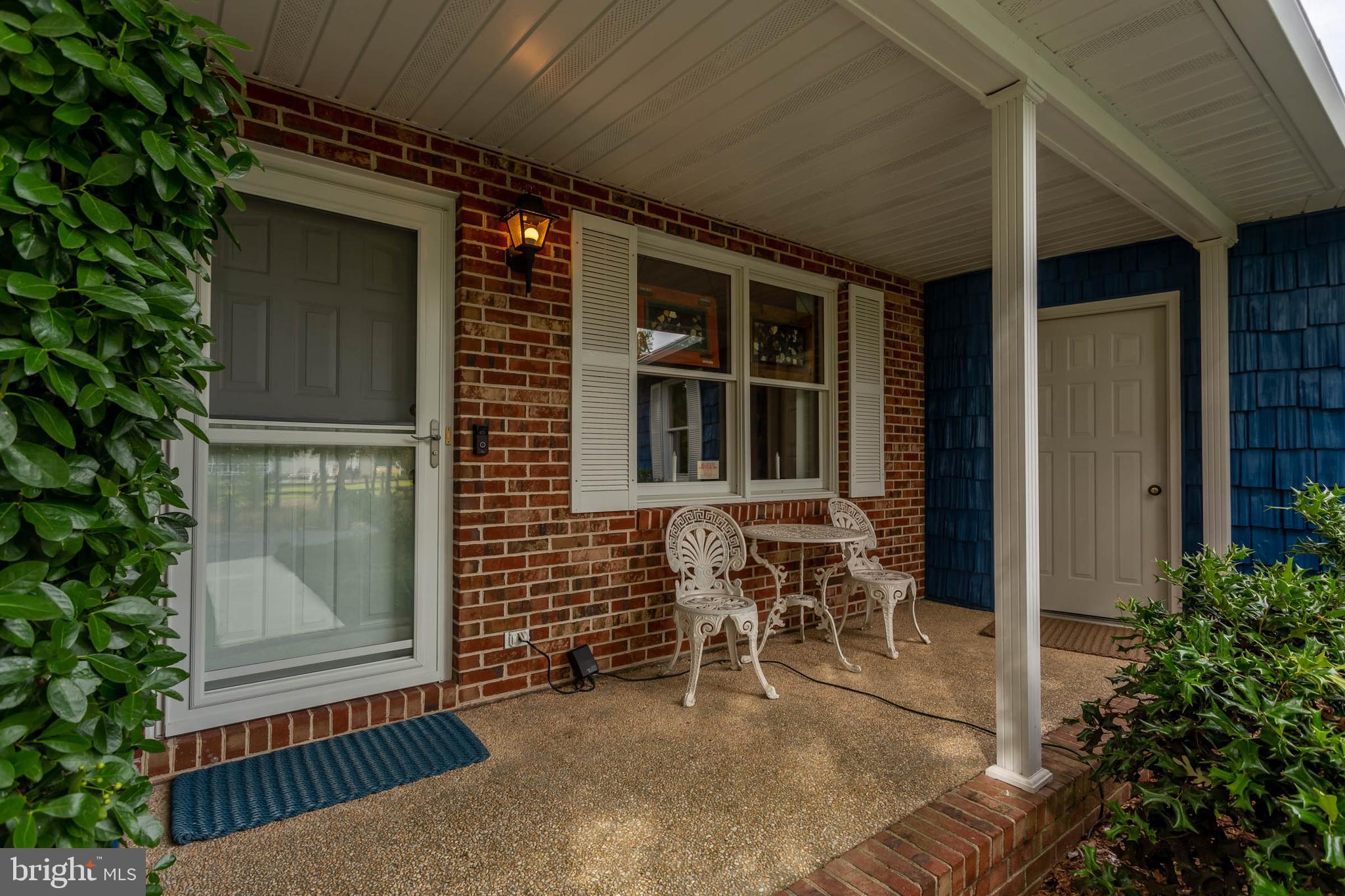32396 Holly Ter Road Ocean View, DE 19970 - Photo 2 of 42 a porch with seating space and garden space