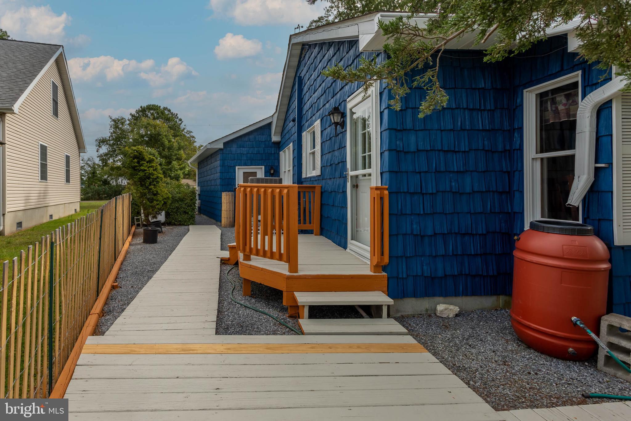 32396 Holly Ter Road Ocean View, DE 19970 - Photo 24 of 42 a bench is sitting in front of a building