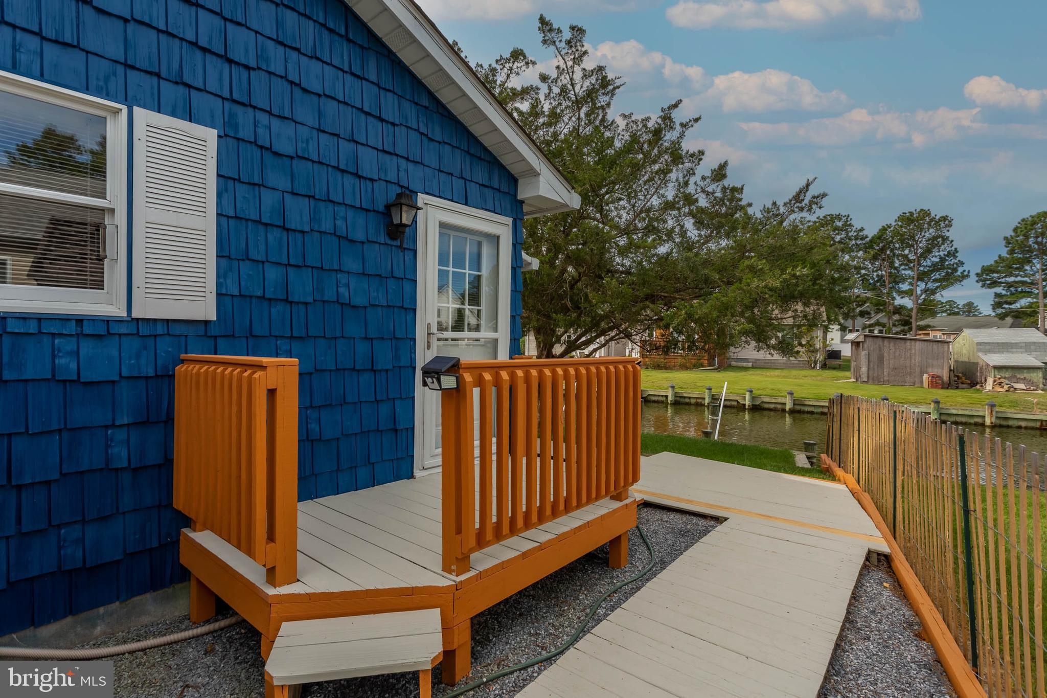 32396 Holly Ter Road Ocean View, DE 19970 - Photo 25 of 42 a view of a patio with chairs next to a yard